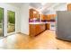 Kitchen featuring wood cabinets, white appliances, stainless steel fridge, and deck access at 252 Fox Ridge, Pittsboro, NC 27312