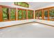 The living room with large windows surrounding the room with views of the surrounding trees at 252 Fox Ridge, Pittsboro, NC 27312