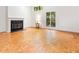 Bright living room with a fireplace and large windows overlooking the trees at 252 Fox Ridge, Pittsboro, NC 27312