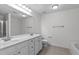 Bathroom with double sinks, large mirror, toilet, bathtub, and tiled floor, and modern fixtures at 2621 Asher View Ct, Raleigh, NC 27606