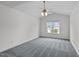 Spacious primary bedroom with one window for natural light, ceiling fan, and neutral carpeting at 2621 Asher View Ct, Raleigh, NC 27606