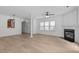 Open living space with hardwood floors, neutral walls, and fireplace at 2621 Asher View Ct, Raleigh, NC 27606