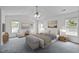 Spacious main bedroom with a vaulted ceiling, plush carpeting, and abundant natural light at 2621 Asher View Ct, Raleigh, NC 27606
