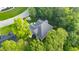 Overhead view of a home surrounded by mature trees, highlighting its location and roof architecture at 3024 Weston Ct, Burlington, NC 27215