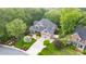 Aerial view of a home with a well-manicured lawn, driveway, and landscaping, highlighting its curb appeal at 3024 Weston Ct, Burlington, NC 27215