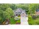Beautiful home with lush landscaping, mature trees, and an inviting driveway creating a picturesque setting at 3024 Weston Ct, Burlington, NC 27215