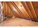 Exposed beams and plywood floors are visible in the unfinished attic space at 3024 Weston Ct, Burlington, NC 27215