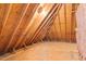 An unfinished attic shows exposed beams and pink insulation at 3024 Weston Ct, Burlington, NC 27215