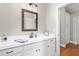 Bathroom featuring a white vanity with a dark framed mirror and updated fixtures at 3024 Weston Ct, Burlington, NC 27215