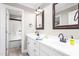 Bathroom showcasing a dual sink vanity, framed mirrors, and an entryway to the bath at 3024 Weston Ct, Burlington, NC 27215