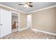 Bedroom showcases a ceiling fan, neutral walls, and flooring with two entryways at 3024 Weston Ct, Burlington, NC 27215