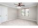 Bedroom features neutral walls, carpeting, a fan, and a window with blinds at 3024 Weston Ct, Burlington, NC 27215