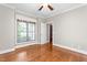 Wood-floored bedroom featuring a window with blinds and an adjacent bathroom entrance at 3024 Weston Ct, Burlington, NC 27215