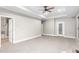 Bedroom with neutral carpet, white trim, and a view to an en-suite bath at 3024 Weston Ct, Burlington, NC 27215