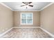 Bedroom showcases a ceiling fan, neutral walls, and flooring at 3024 Weston Ct, Burlington, NC 27215