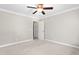 Neutral carpeted bedroom features a ceiling fan and white trim throughout at 3024 Weston Ct, Burlington, NC 27215