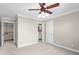 Bedroom showing neutral walls, carpet, a fan and entryways to a hallway and ensuite bathroom at 3024 Weston Ct, Burlington, NC 27215