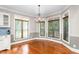 Bright dining area featuring hardwood floors, a chandelier, and a breakfast bar next to the kitchen at 3024 Weston Ct, Burlington, NC 27215