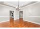 Open dining room with hardwood floors, a view of kitchen and staircase, and decorative trim at 3024 Weston Ct, Burlington, NC 27215