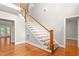 Bright foyer features gleaming wood floors, a staircase with white risers, and a transom window at 3024 Weston Ct, Burlington, NC 27215