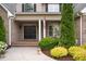 Inviting entrance features a charming front porch with meticulous landscaping and manicured shrubbery at 3024 Weston Ct, Burlington, NC 27215