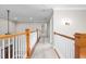 Hallway featuring neutral carpeting, trim, and lighting with white doors at 3024 Weston Ct, Burlington, NC 27215