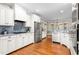 Bright kitchen featuring white cabinets, stainless steel appliances, and granite countertops at 3024 Weston Ct, Burlington, NC 27215