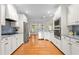 Spacious kitchen with white cabinets, stainless steel appliances, and granite countertops at 3024 Weston Ct, Burlington, NC 27215