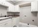 Functional laundry room with white cabinets, a sink, and utility hookups at 3024 Weston Ct, Burlington, NC 27215