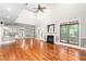 Bright open-concept living space with a fireplace, kitchen view, and hardwood flooring at 3024 Weston Ct, Burlington, NC 27215