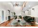 Bright living room with fireplace, soaring ceilings, statement furniture, hardwood floors, and second floor view at 3024 Weston Ct, Burlington, NC 27215