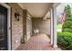Cozy porch with brick flooring and pillars, perfect for relaxing and enjoying the outdoors at 3024 Weston Ct, Burlington, NC 27215