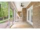 Brick patio has a screened-in porch featuring a ceiling fan and a view of the backyard at 3024 Weston Ct, Burlington, NC 27215
