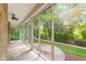 Screened porch with ceiling fan and views of the lush backyard at 3024 Weston Ct, Burlington, NC 27215