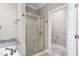 Shower with glass door, bronze hardware, and tiled surround at 3024 Weston Ct, Burlington, NC 27215