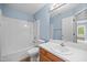 Bathroom featuring a tub with shower, single sink vanity, and a mirrored wall at 304 Gold Point Dr, Cary, NC 27519