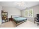 Inviting bedroom features neutral tones, large windows, and vaulted ceiling, offering bright, airy space at 304 Gold Point Dr, Cary, NC 27519