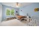 Well-lit bedroom with a ceiling fan, window, and playful decor at 304 Gold Point Dr, Cary, NC 27519