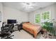 Bright bedroom featuring a ceiling fan, natural light and a dedicated desk area at 304 Gold Point Dr, Cary, NC 27519