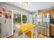 Bright dining area with a wood table, white chairs, and view of the backyard at 304 Gold Point Dr, Cary, NC 27519