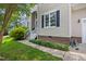 Exterior view of a home with pristine lawn and tidy landscaping near the front door at 304 Gold Point Dr, Cary, NC 27519
