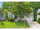 Charming two-story home boasts a well-manicured lawn and attached garage, framed by mature trees at 304 Gold Point Dr, Cary, NC 27519