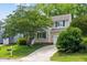 Charming two-story home features a well-maintained lawn, manicured landscaping and attached garage at 304 Gold Point Dr, Cary, NC 27519
