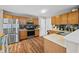 Well-lit kitchen featuring stainless steel appliances, oak cabinets, and sleek hardware at 304 Gold Point Dr, Cary, NC 27519