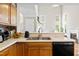 The kitchen features wood cabinets, stainless steel sink, and open layout with views to the living spaces at 304 Gold Point Dr, Cary, NC 27519