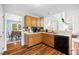 Kitchen with wood cabinets, stainless steel sink, and views into the dining and living spaces at 304 Gold Point Dr, Cary, NC 27519