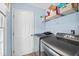 Functional laundry room equipped with modern washer and dryer units and storage shelves at 304 Gold Point Dr, Cary, NC 27519