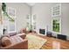 Spacious living room with high ceilings, many windows, a fireplace and hardwood floors at 304 Gold Point Dr, Cary, NC 27519