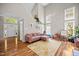 Bright living room featuring high ceilings, many windows, hardwood floors, and stylish decor at 304 Gold Point Dr, Cary, NC 27519