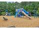 Community playground with slides, climbing structures, and wood chip ground cover for safe play at 304 Gold Point Dr, Cary, NC 27519